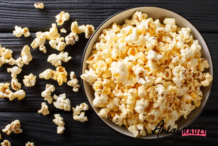 Uprażony popcorn w misce na czarnym tle oraz porady, jak zrobić popcorn
